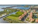 Aerial view highlighting a waterfront townhouse community with lush landscaping and a canal at 1309 3Rd Street E Cir, Palmetto, FL 34221