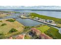 An aerial view showcasing a waterfront townhouse with a private driveway and canal views at 1309 3Rd Street E Cir, Palmetto, FL 34221