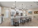 Modern kitchen with stainless steel appliances, a large island, pendant lighting and bar stool seating at 4611 Trento Pl, Bradenton, FL 34211