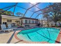 Inviting pool area with covered patio, lounge chairs, and brick coping at 151 Adair Ave, Sarasota, FL 34243