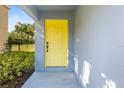 Inviting yellow front door entrance with landscaping at 206 Beacon Harbour Loop, Bradenton, FL 34212