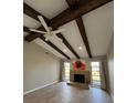 Bright living room with fireplace and high ceilings, featuring exposed wooden beams at 4409 Eleuthera Ct, Sarasota, FL 34233