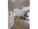 Bright living room with tile floors, comfy seating, and large windows at 4409 Eleuthera Ct, Sarasota, FL 34233