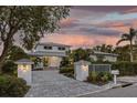 Modern two-story home with a metal roof, gated entry, and paved driveway at 1718 Bay St, Sarasota, FL 34236