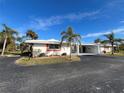 White single story home with carport and palm trees at 1741 Caribbean Cir # 13, Venice, FL 34293