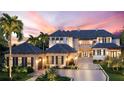 Elegant two-story home with a grand entrance and landscaped grounds at 3990 Higel Ave, Sarasota, FL 34242