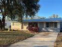 Cute ranch home with gray exterior, landscaping, and driveway at 4951 Bell Meade Dr, Sarasota, FL 34232