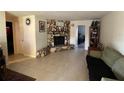 Living room featuring a stone fireplace and tile flooring at 4951 Bell Meade Dr, Sarasota, FL 34232