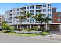 Modern building with sign that reads TENERIFE SEASIDE and lush landscaping for a tranquil and luxurious feel at 1035 Seaside Dr # 305, Sarasota, FL 34242