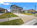 Two-story house with gray siding, teal shutters, and a two-car garage at 4016 86Th E St, Palmetto, FL 34221