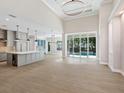 Spacious kitchen with an island, stainless steel appliances and hardwood floors at 616 Mangrove Point Rd, Siesta Key, FL 34242