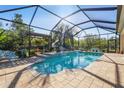 Enclosed pool area with waterfall feature and patio furniture at 7168 Ryedale Ct, Sarasota, FL 34241
