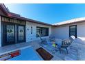 Relaxing front porch with colorful floor tiles and gray chairs at 9363 Steubenville Ave, Englewood, FL 34224