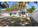 Cute bungalow, white exterior, blue accents, and a fenced yard at 2369 Browning St, Sarasota, FL 34237