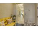 Cozy entryway with stylish decor, a decorative bench, and a peek into the beautifully tiled hallway at 505 Tamiami N Trl # 201, Venice, FL 34285