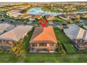 Aerial view of home with pool overlooking a pond in a serene, well-planned community at 5050 Surfside Cir, Lakewood Ranch, FL 34211