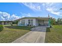 Cute Florida home with a driveway and tropical landscaping at 740 Floral Ln, Port Charlotte, FL 33952