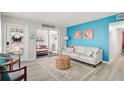 Bright living room featuring a comfy sofa and coastal decor at 740 Floral Ln, Port Charlotte, FL 33952
