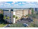 Aerial view of a condo building with parking and water views at 8625 Midnight Pass Rd # 505B, Sarasota, FL 34242
