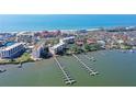 Aerial view of waterfront condo building with boat slips at 8625 Midnight Pass Rd # 505B, Sarasota, FL 34242