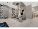 Stunning condo lobby with contemporary design, unique light fixture, and stylish seating area at 111 S Pineapple Ave # 1018, Sarasota, FL 34236
