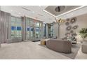 Beautiful condo entrance lobby with glass doors, modern seating area, and elegant lighting at 111 S Pineapple Ave # 1018, Sarasota, FL 34236