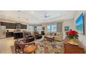 Living room with comfortable seating, a large TV, and a view of the backyard at 13789 Old Creek Ct, Parrish, FL 34219