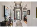 Bright and spacious entryway with console table and modern artwork at 17424 Cresswind Ter, Bradenton, FL 34211