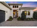 Front entrance of a house with walkway, landscaping, and a gray door at 17424 Cresswind Ter, Bradenton, FL 34211