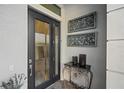 Elegant black front door with glass panels and decorative wall art at 17424 Cresswind Ter, Bradenton, FL 34211