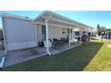 Mobile home with covered patio, parking, and landscaped yard at 3333 26Th E Ave # 1107, Bradenton, FL 34208