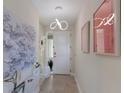 Bright and airy entryway with modern art and a view to the living area at 3431 79Th Street W Cir # 102, Bradenton, FL 34209