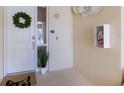 Front door entryway with wreath, small plant, and floor mat at 3431 79Th Street W Cir # 102, Bradenton, FL 34209