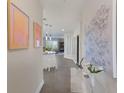 Long hallway with modern wall art and views into living and kitchen areas at 3431 79Th Street W Cir # 102, Bradenton, FL 34209