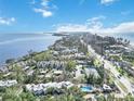 Wide aerial view of coastal community, showcasing its beachfront location and amenities at 5310 Gulf Of Mexico Dr # 11, Longboat Key, FL 34228