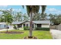 House with gray exterior, palm trees, and well-manicured lawn at 6201 34Th W Ave, Bradenton, FL 34209