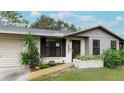 Home's front entrance with walkway, landscaping, and a gray exterior at 6201 34Th W Ave, Bradenton, FL 34209