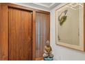 Entryway with wood door and modern artwork at 1255 N Gulfstream Ave # Ph1501, Sarasota, FL 34236