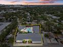 Aerial view of a property with a pool and surrounding houses at 2069 Bougainvillea St, Sarasota, FL 34239