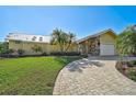 Exterior of single-story home with a paved driveway and landscaping at 219 Keel Way, Osprey, FL 34229