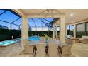 Covered patio with comfortable seating and a pool view at 4730 Zeno Ct, Bradenton, FL 34211