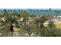 Aerial view of waterfront property with palm trees and city skyline in background at 800 N Tamiami Trl # 403, Sarasota, FL 34236