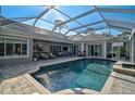 Inviting pool and spa area with covered patio at 85 Sugar Mill Dr, Osprey, FL 34229