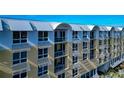 Close-up of condo building exterior, highlighting the unique window shades at 915 Seaside Dr # 604, Sarasota, FL 34242