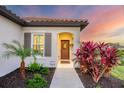 Inviting front door entrance with lush landscaping and a walkway at 12735 Aquamarine Ave, Bradenton, FL 34211