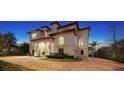 Elegant waterfront home at dusk showcasing its brick driveway at 1430 Harbor Dr, Sarasota, FL 34239