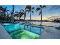 Beautiful waterfront pool with palm trees, boat dock, and sunset views at 1430 Harbor Dr, Sarasota, FL 34239