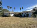 Side view of a single-story home with a large yard at 461 S Florida Ave, Tarpon Springs, FL 34689