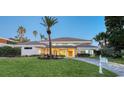 Two-story home with manicured lawn and inviting entryway at 50 Lighthouse Point Dr, Longboat Key, FL 34228