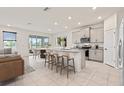 Modern kitchen with an island, stainless steel appliances, and granite countertops at 5316 Rocky Coast Place, Palmetto, FL 34221